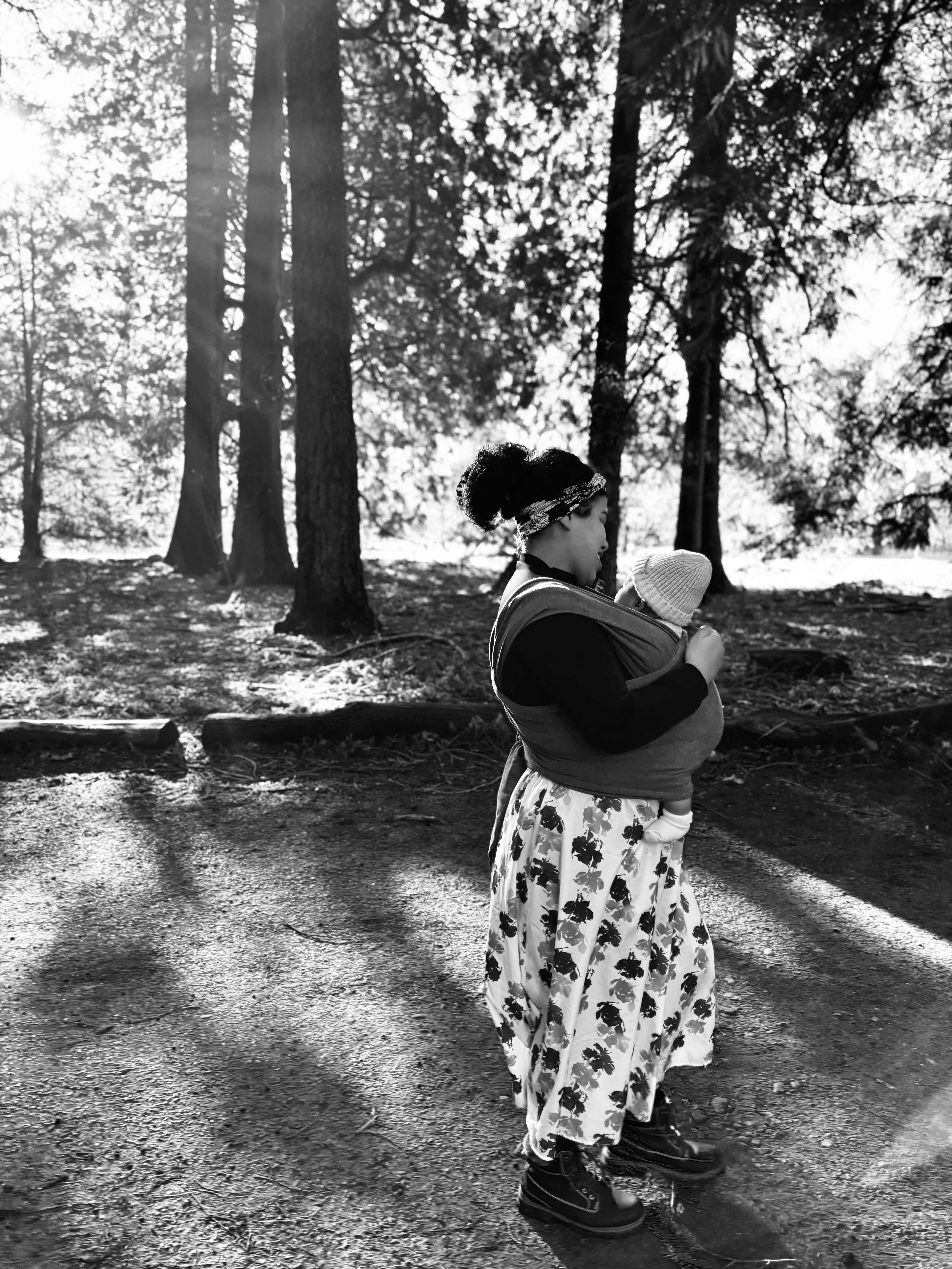 Vanessa E. Briceño walking with her child in the forest, a quiet moment of presence and attention